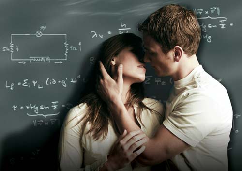 A photo of a boy and girl kissing against a chalk board