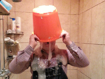 A photo of a person with a bucket of foam on their head.