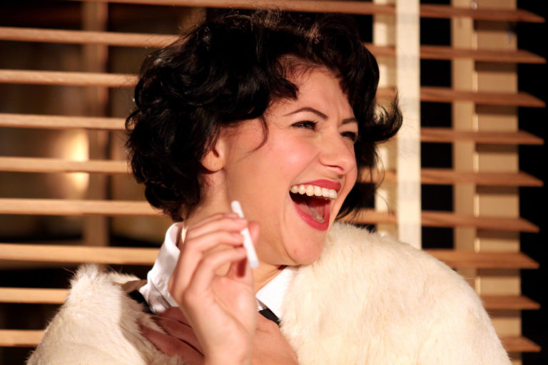 A photo of Jess Mabel Jones laughing and looking to the left