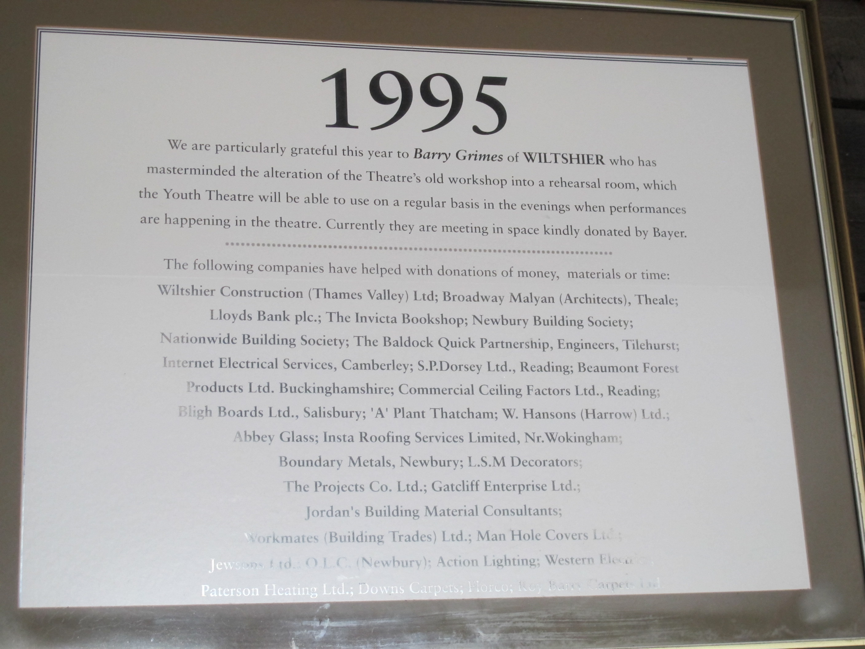 A photograph taken of the plaque commemorating the building of The Watermills rehearsal room