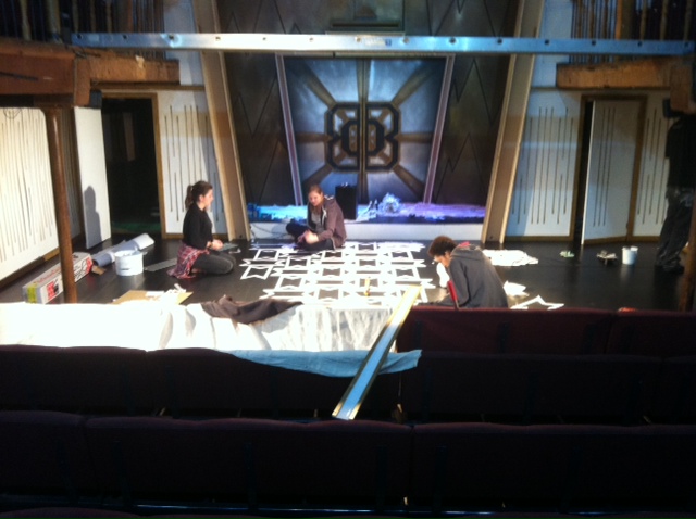A photograph taken of creatives working on a set.