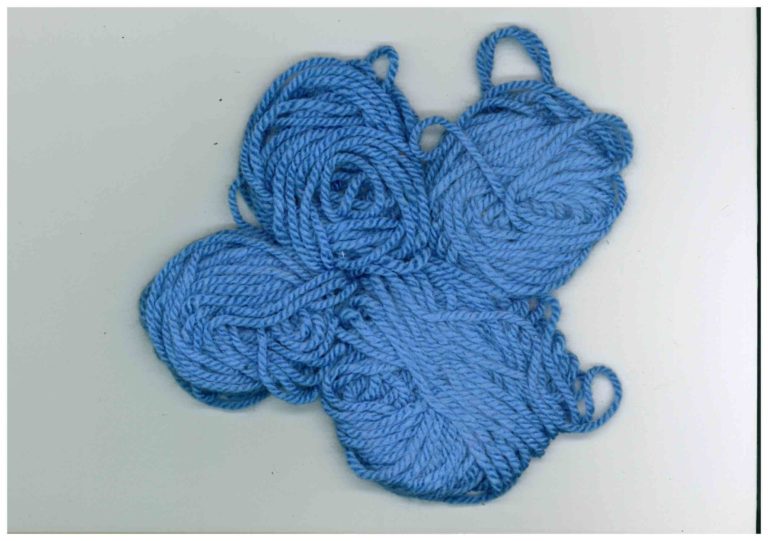 A photo of four balls of blue wool.
