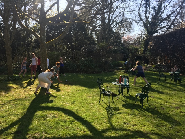 A photograph of rehearsals in the garden.